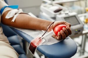 closeup-black-woman-donating-blood-focus-hand-holding-red-ball-with-tubing-copy-space-scaled.jpg