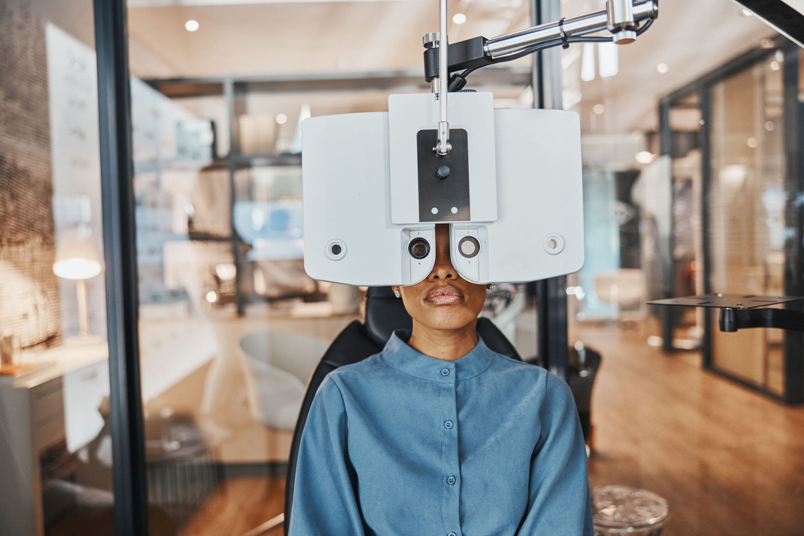 optometry-eye-exam-black-woman-vision-healthcare-test-optical-assessment-glasses-ophthalmology-optometrist-clinic-patient-with-medical-equipment-phoropter-lens-eyes-scaled.jpg