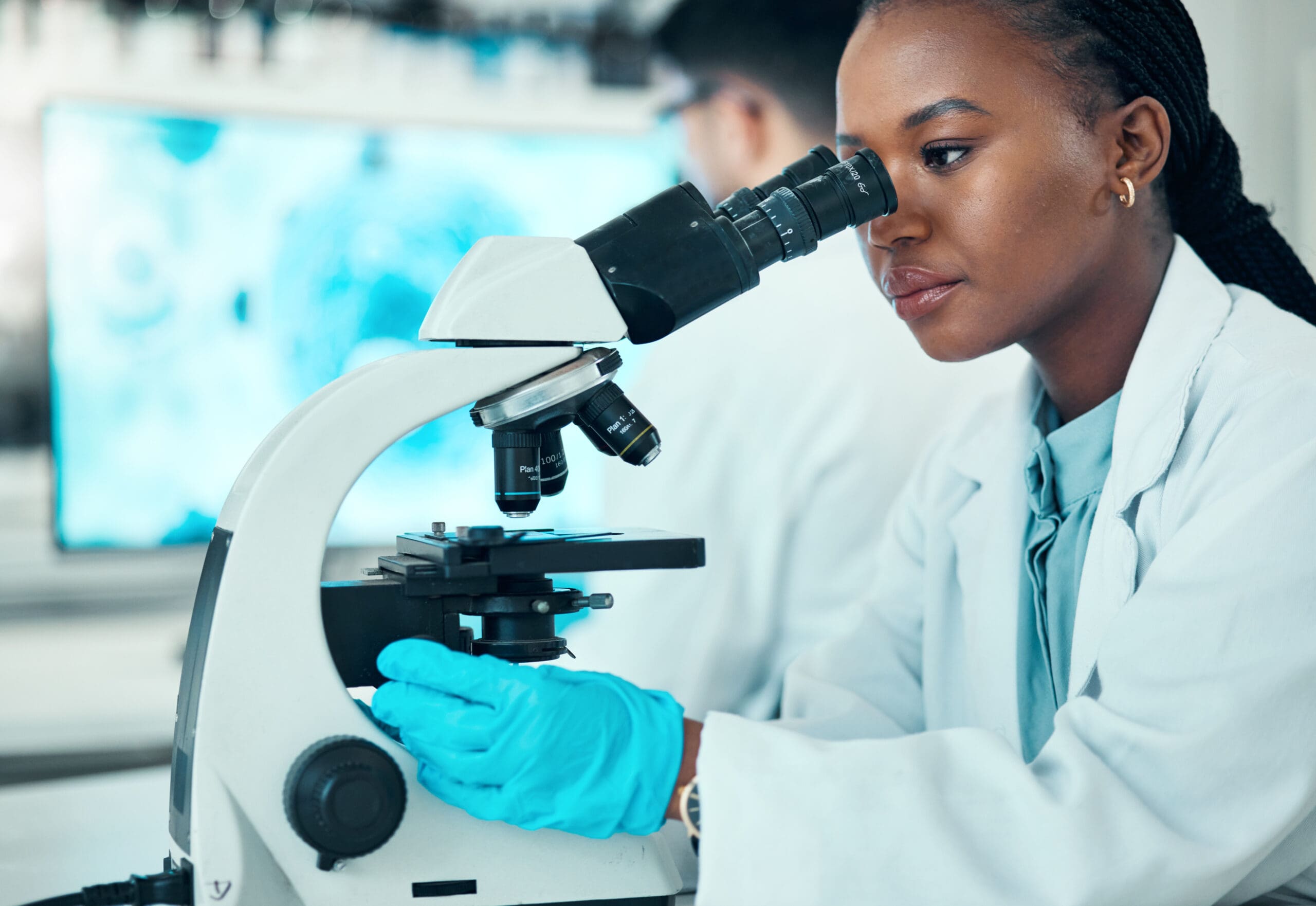 microscope-science-female-scientist-lab-medical-pharmaceutical-research-professional-scientific-african-woman-researcher-working-molecule-analysis-with-biotechnology-equipment-scaled.jpg