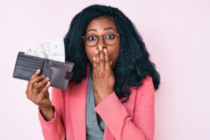 beautiful-african-woman-holding-wallet-with-dollars-covering-mouth-with-hand-shocked-afraid-mistake-surprised-expression-scaled.jpg