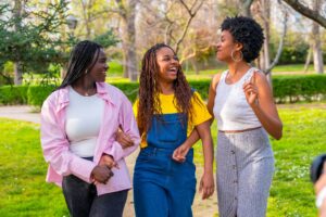 friends-walking-chatting-along-park-scaled.jpg