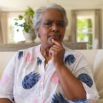 portrait-senior-african-american-woman-sitting-sofa-looking-camera-scaled.jpg