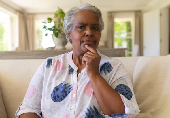 portrait-senior-african-american-woman-sitting-sofa-looking-camera-scaled.jpg
