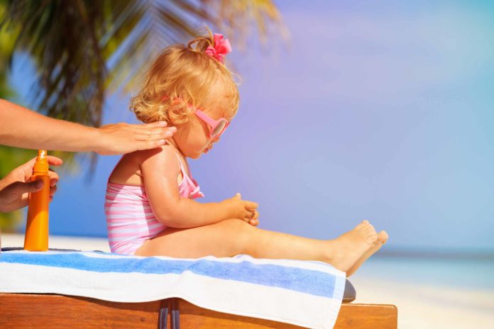 Toddler-getting-sunscreen-applied-2500-1666-696x464-1.jpg